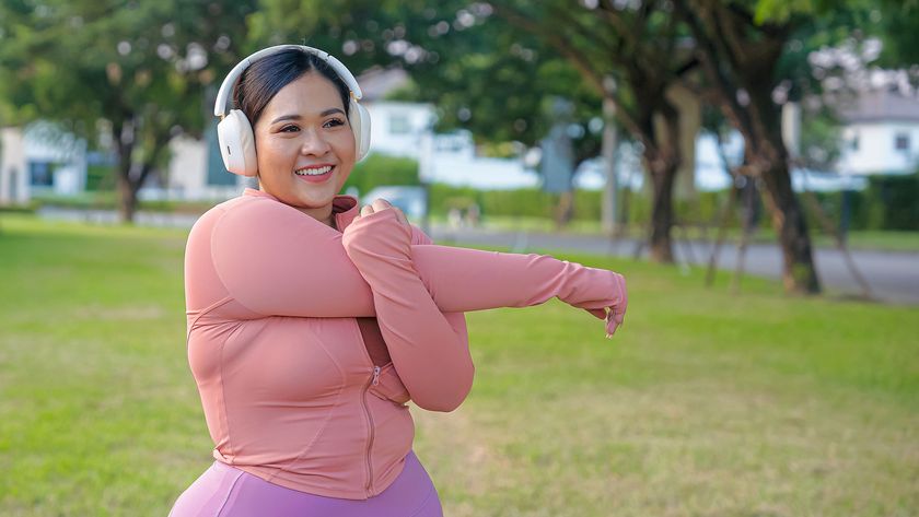 A picture of a woman stretching after a run in a park