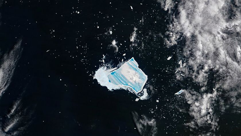 Satellite photo of an iceberg covered with vibrant blue stripes in the middle of the ocean
