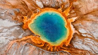An aerial photograph of the Grand Prismatic Spring in Yellowstone. 