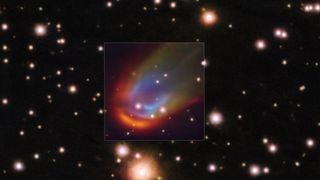 Image showing a multicolored bow shock surrounding a distant star