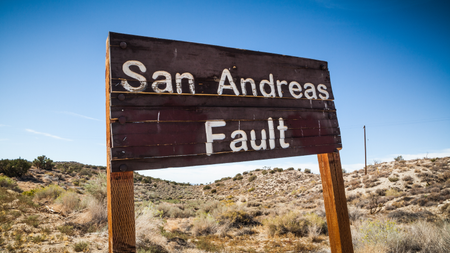 A sign posted where the San Andreas Fault intersects with Pallet Creek Road in Pearblossom California, a small town in Los Angeles County.