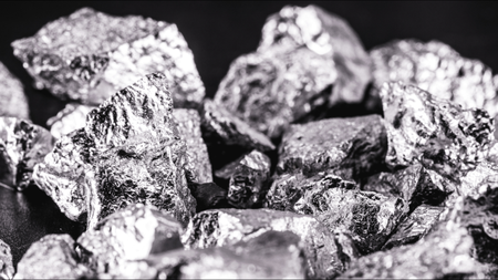 Iridium photographed on a black surface. Iridium is a metallic chemical element belonging to the class of transition metals, silver. Used in high strength alloys that can withstand high temperatures